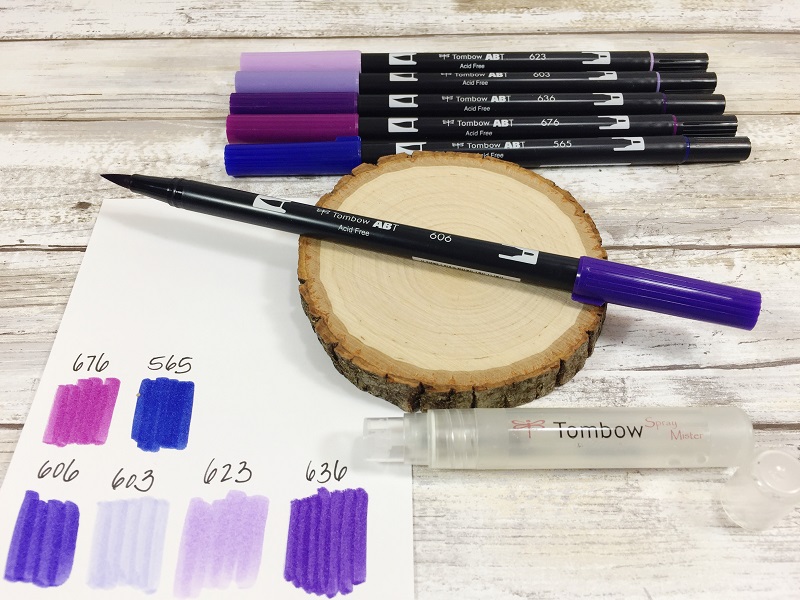 Learn how to make Ultra Violet Faux Agates on a wood slice with Tombow Dual Brush Pens, the Tombow Mister and Tombow MONO Aqua Liquid Glue