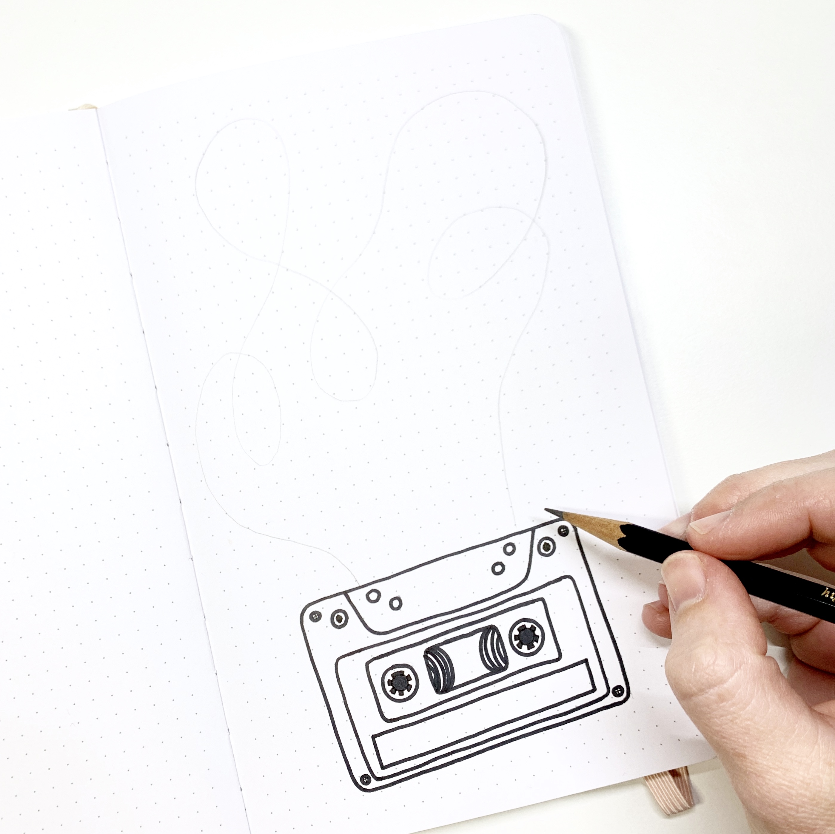 Learn how to create a cassette tape habit tracker in your dot grid notebook with Adrienne from @studio80design!