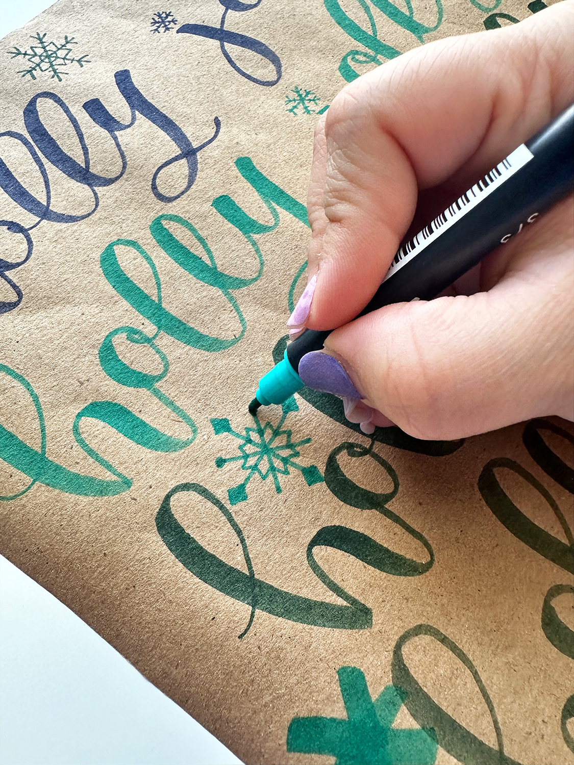 Use lettering to create your own wrapping paper using the Tombow Dual Brush Pens. Draw smaller doodles to fill the gap. #tombow #giftwrapping