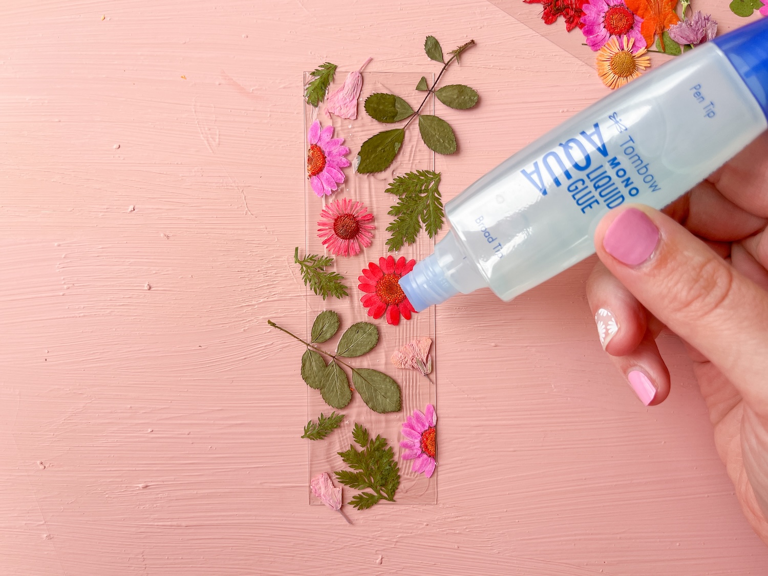 Use Tombow MONO Aqua Liquid Glue to add a clear topcoat over your dried flowers