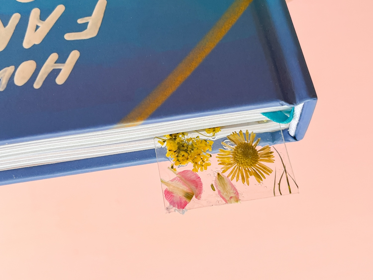Dried Flower Bookmark peeking out of a book