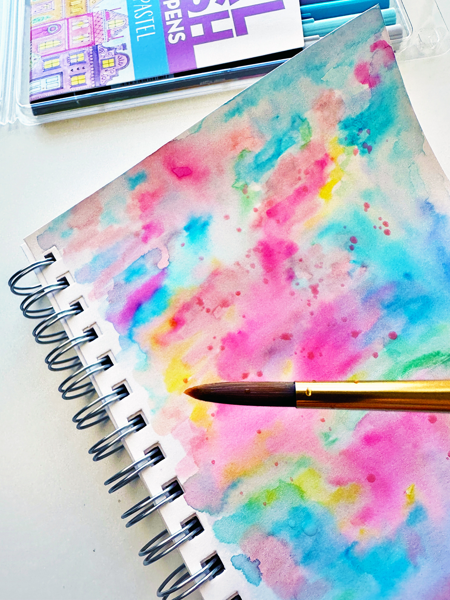 Add splatters! Scribble with the Tombow Dual Brush Pens on a Tombow Blending Palette. Add water and pick up the color with a brush. Tap on the brush to create splatters. #tombow #watercolor