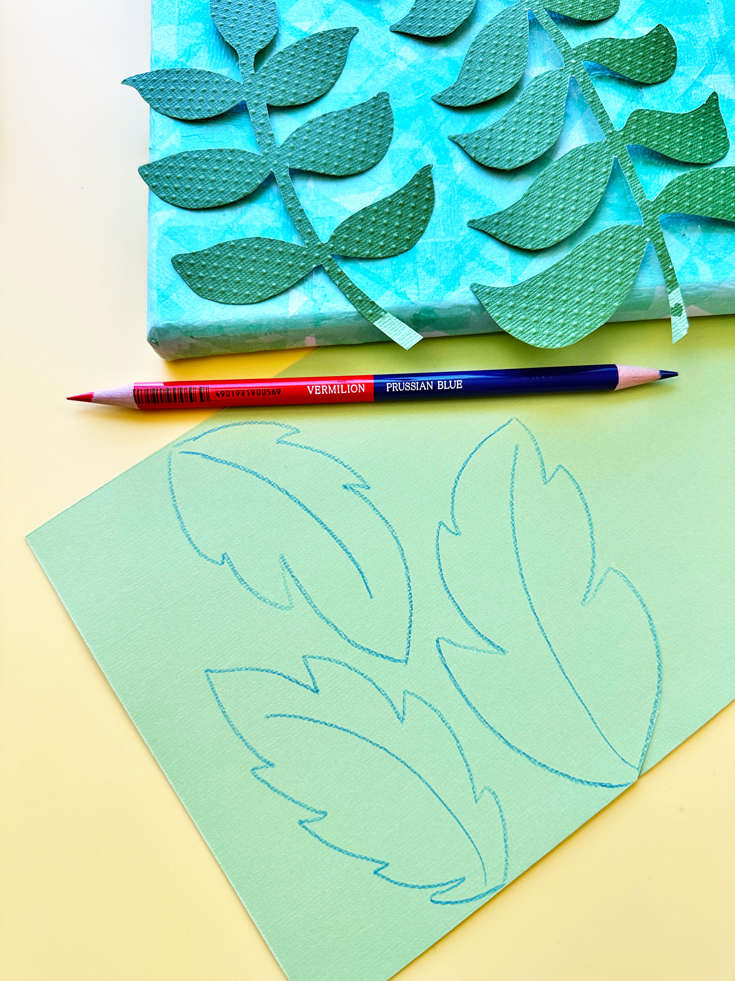 Use cardstock or pattern paper to create leaves. I used a Tombow 8900-VP Colored Pencil to draw on the back of the paper before cutting. 