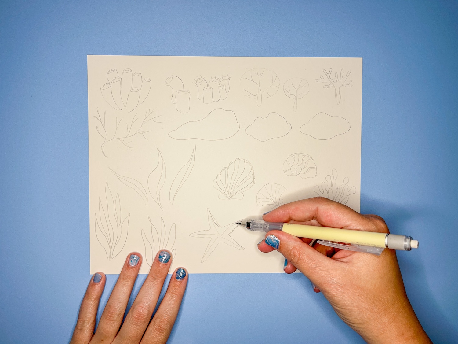 Hand holding Tombow MONO Graph Mechanical Pencil sketching Coral Reef Doodles