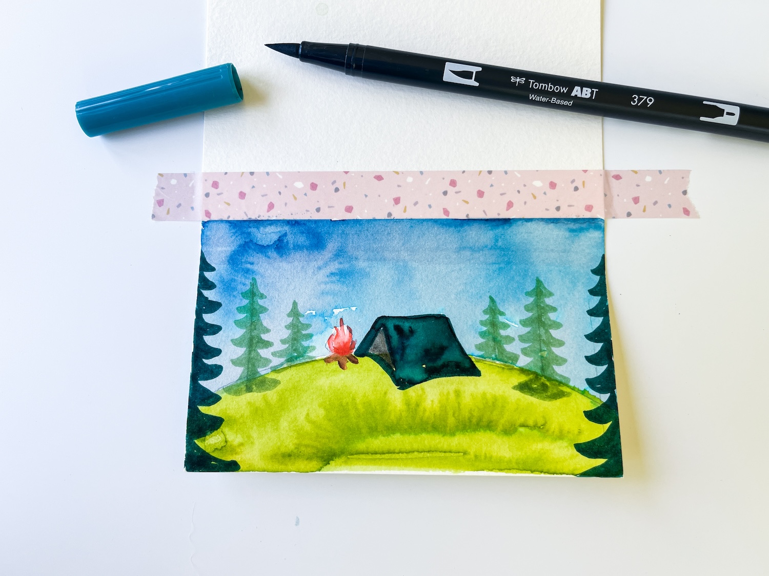 Use Dual Brush Pen 379 to color in the tent and trees in this DIY S'mores Packs by @tombowusa & @studiokatie
