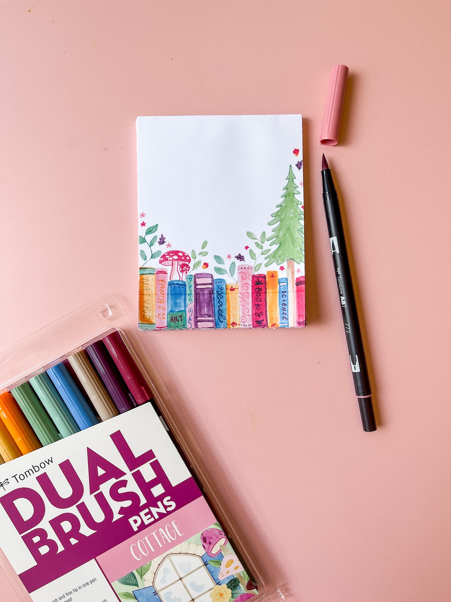 Learn how to make a DIY Notepad with a cute book theme using @tombowusa Dual Brush Pens and MONO Aqua Liquid Glue!