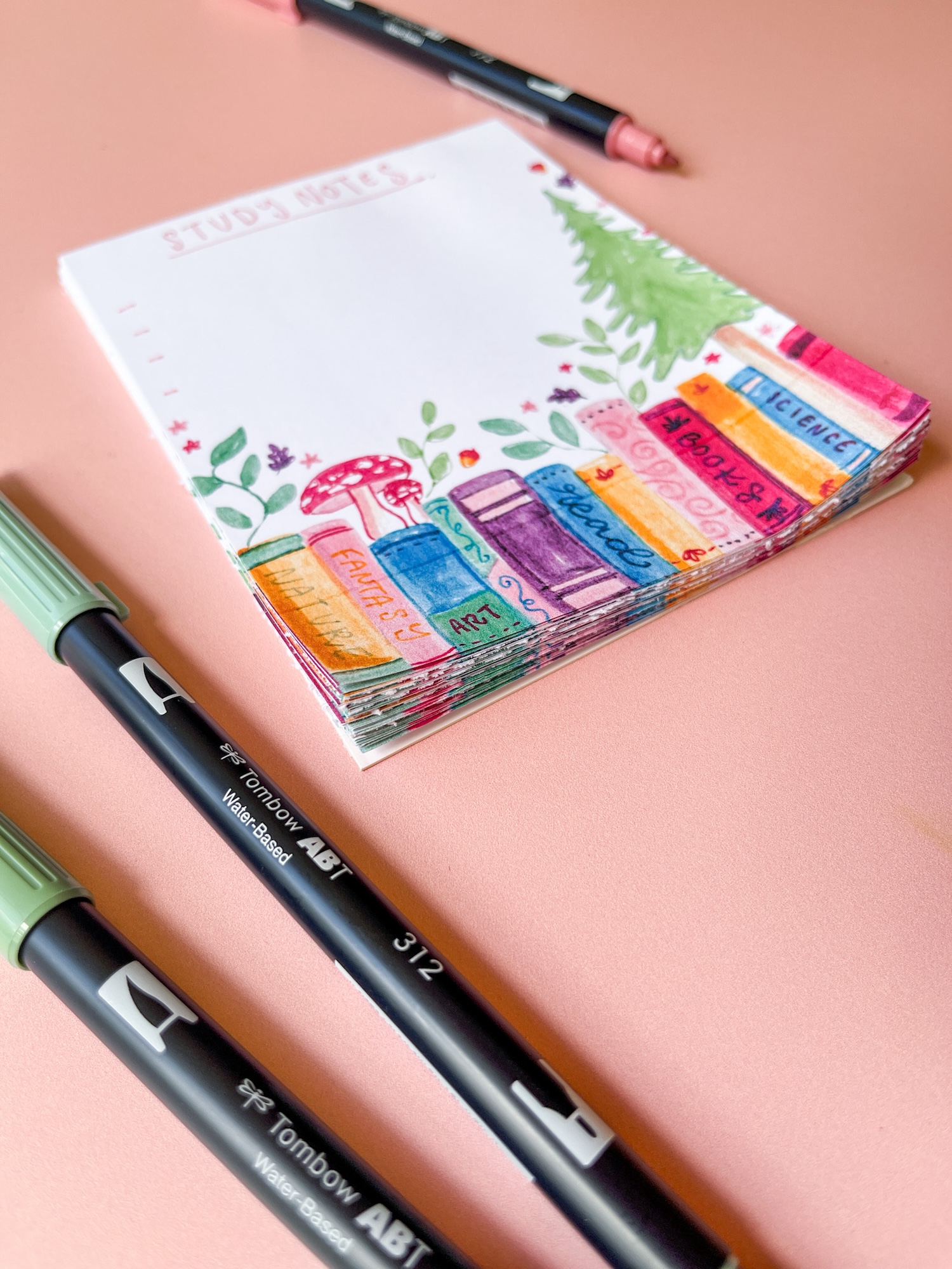  Learn how to make a DIY Notepad with a cute book theme using Tombow Dual Brush Pens and MONO Aqua Liquid Glue!