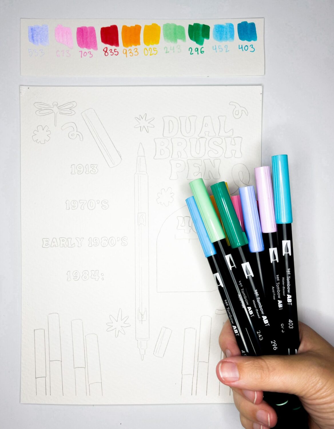Hand holding the Limited Edition Confetti Dual Brush Pen set from @tombowusa