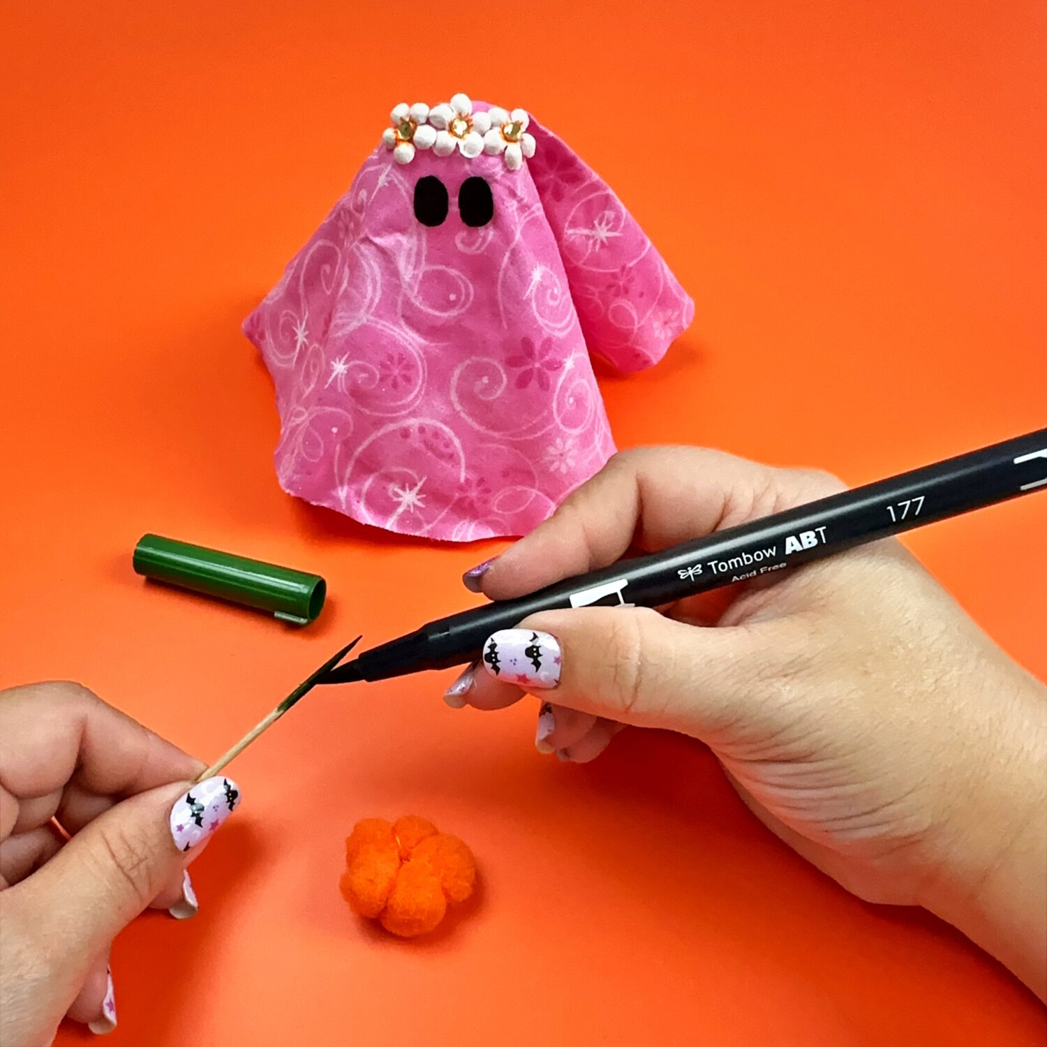 Make a hippie ghost using the Tombow MONO Aqua Liquid Glue and fabric! Use a pompom to add a tiny pumpkin. #tombow #halloweendiy