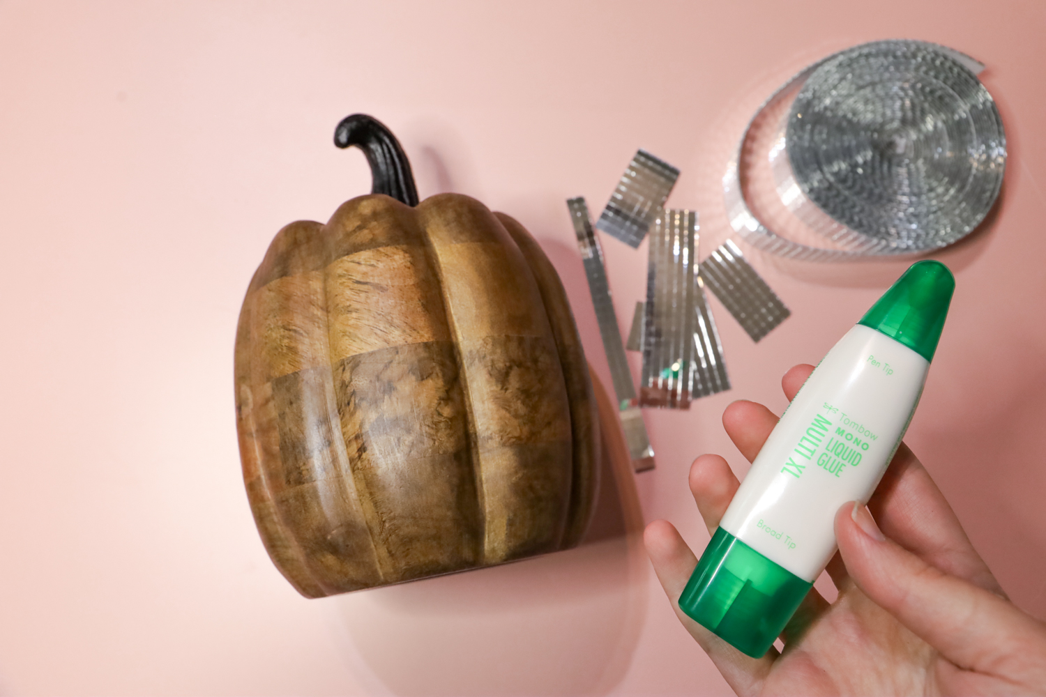 Supplies you'll need to make a Disco Ball Pumpkin: Faux pumpkin, disco tiles, and @tombowusa MONO Multi XL Liquid Glue