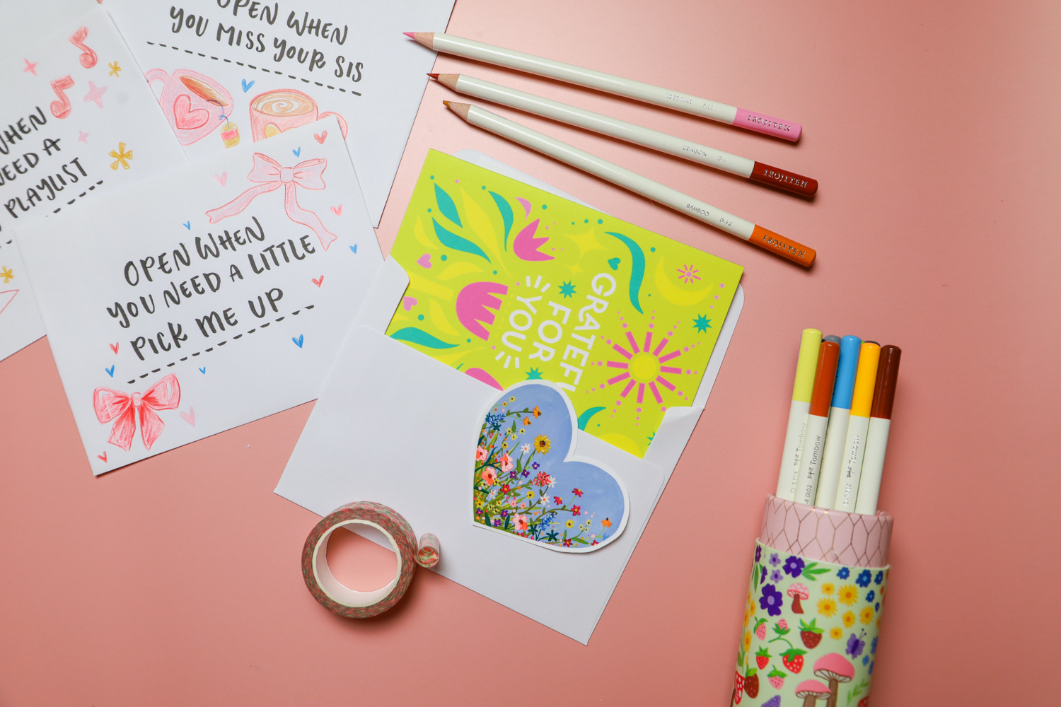 open when letters laying on a desk, handmade with tombow irojiten colored pencils, filled with hand written notes, stickers, washi tape, and more