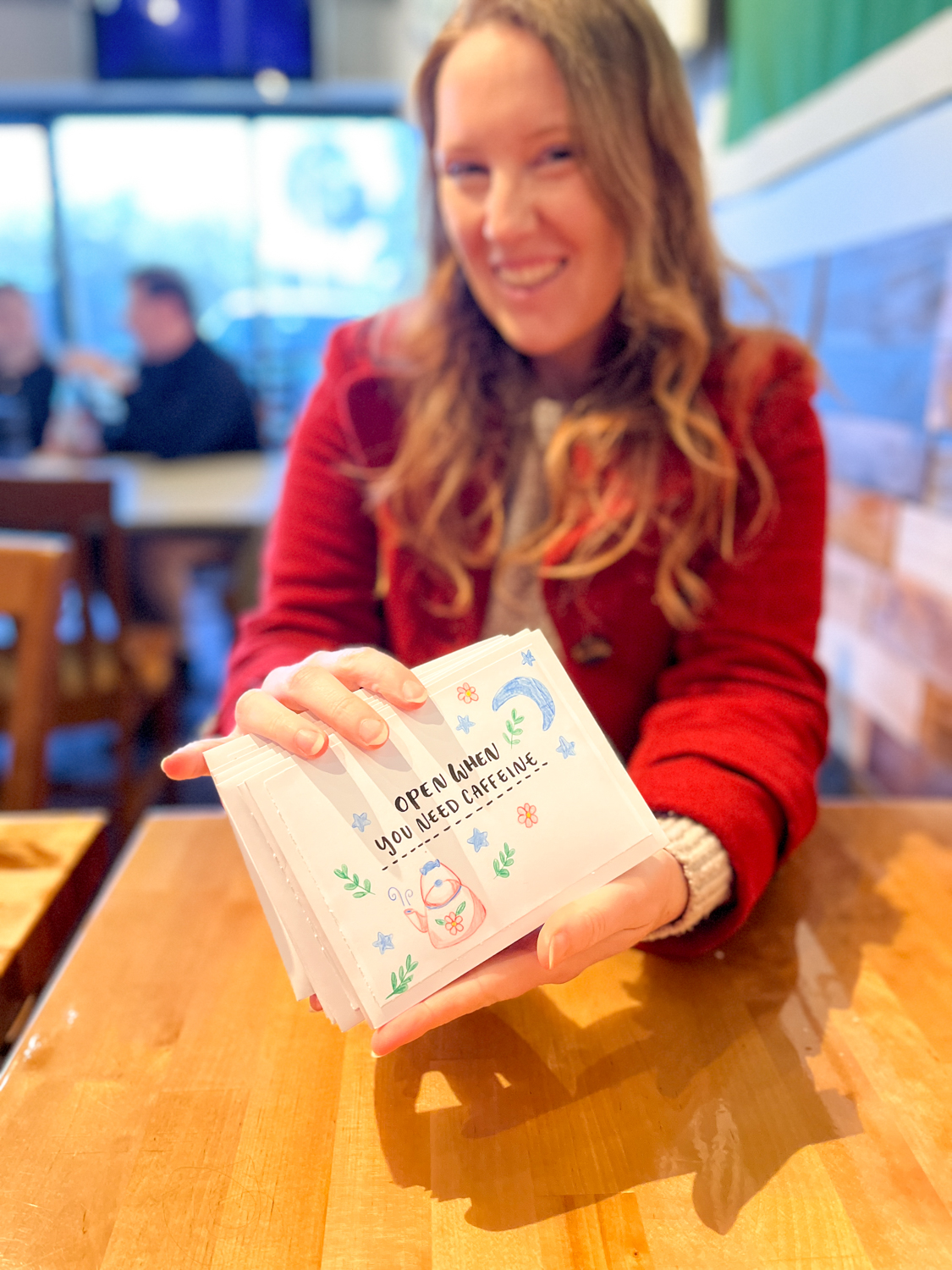 My sister holding her stack of "open when letters" after I gave them to her! Learn how to make your own on the Tombow USA blog!