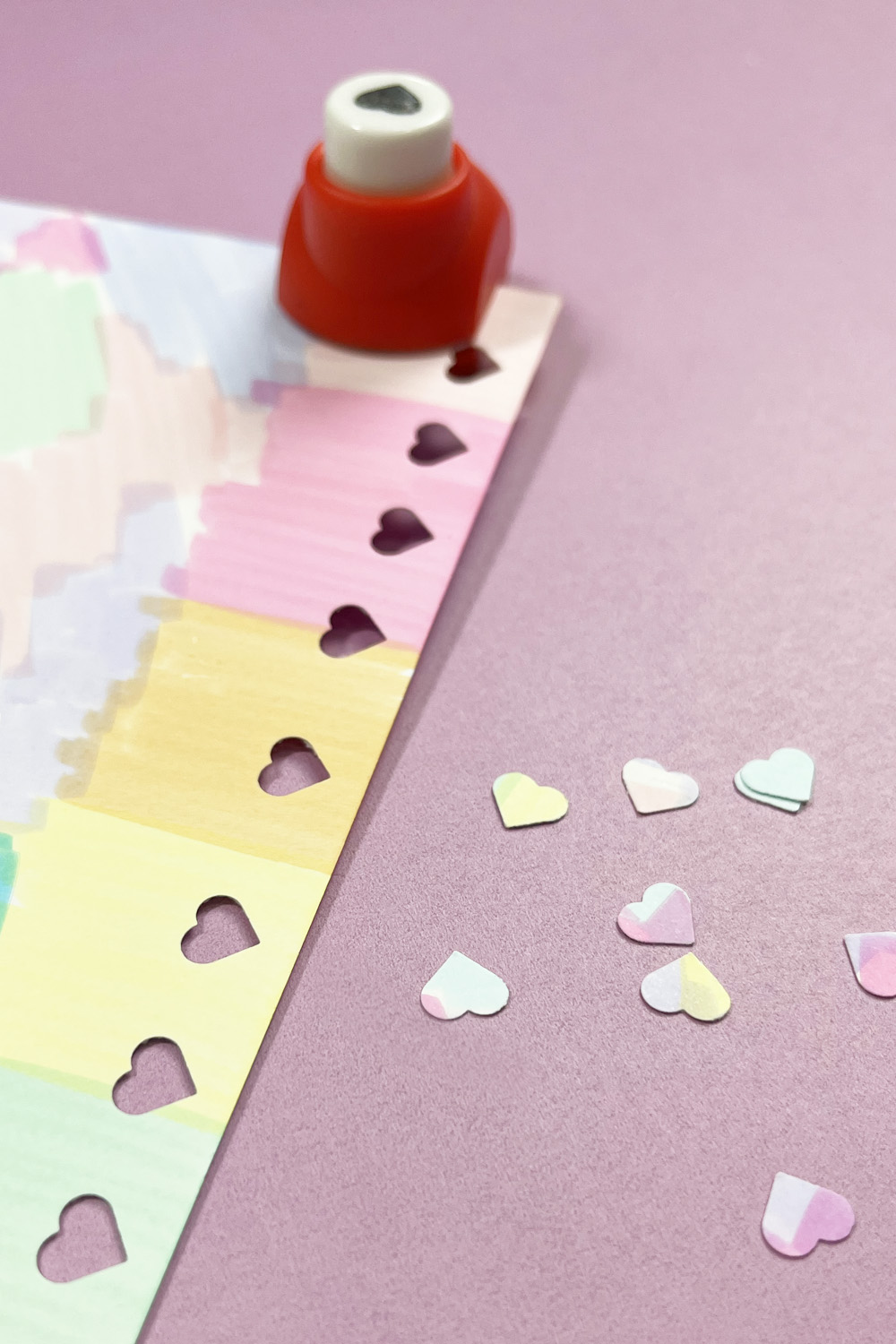 heart punches out of rainbow paper
