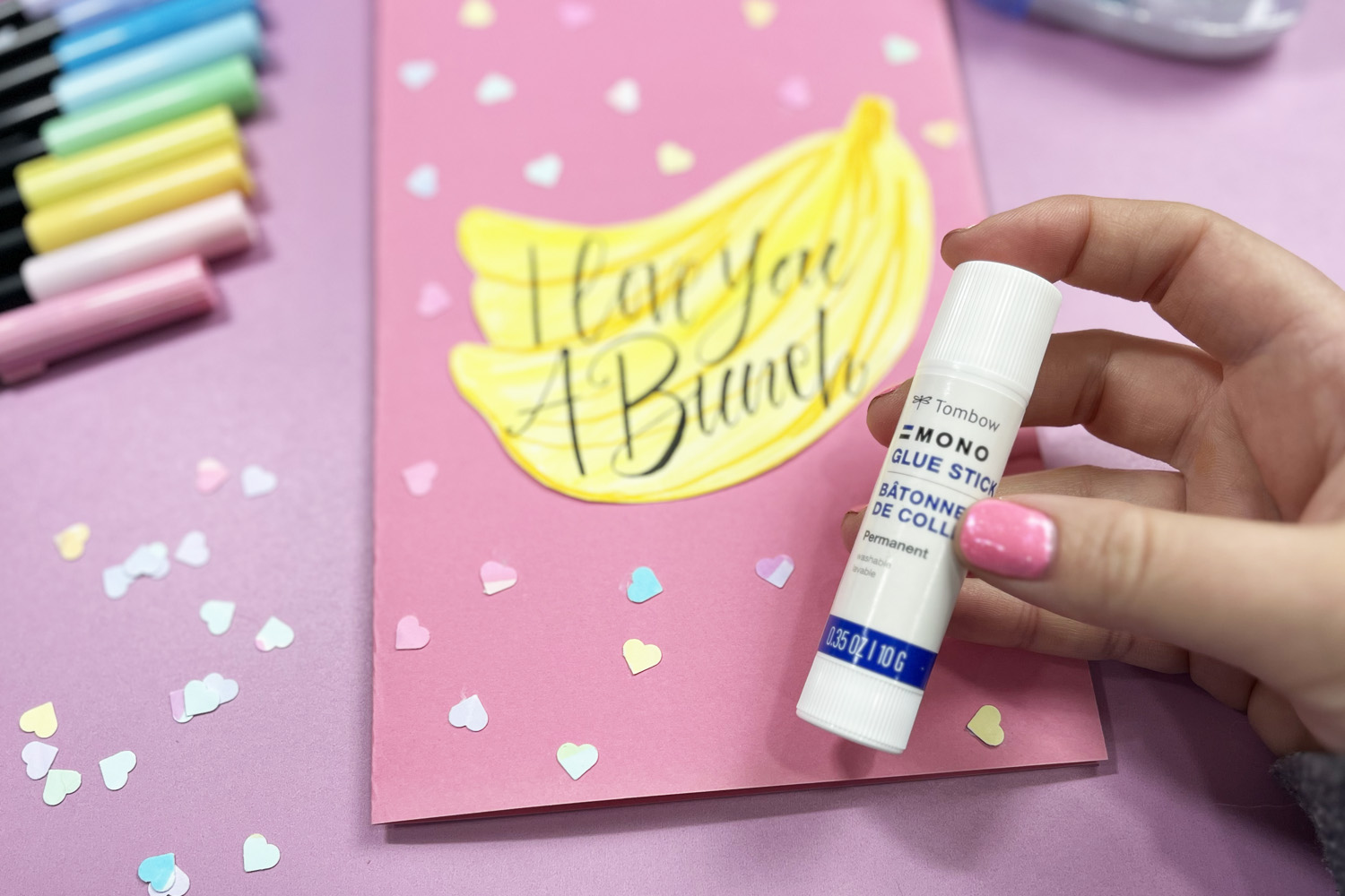 glue stick with bananas and heart confettii