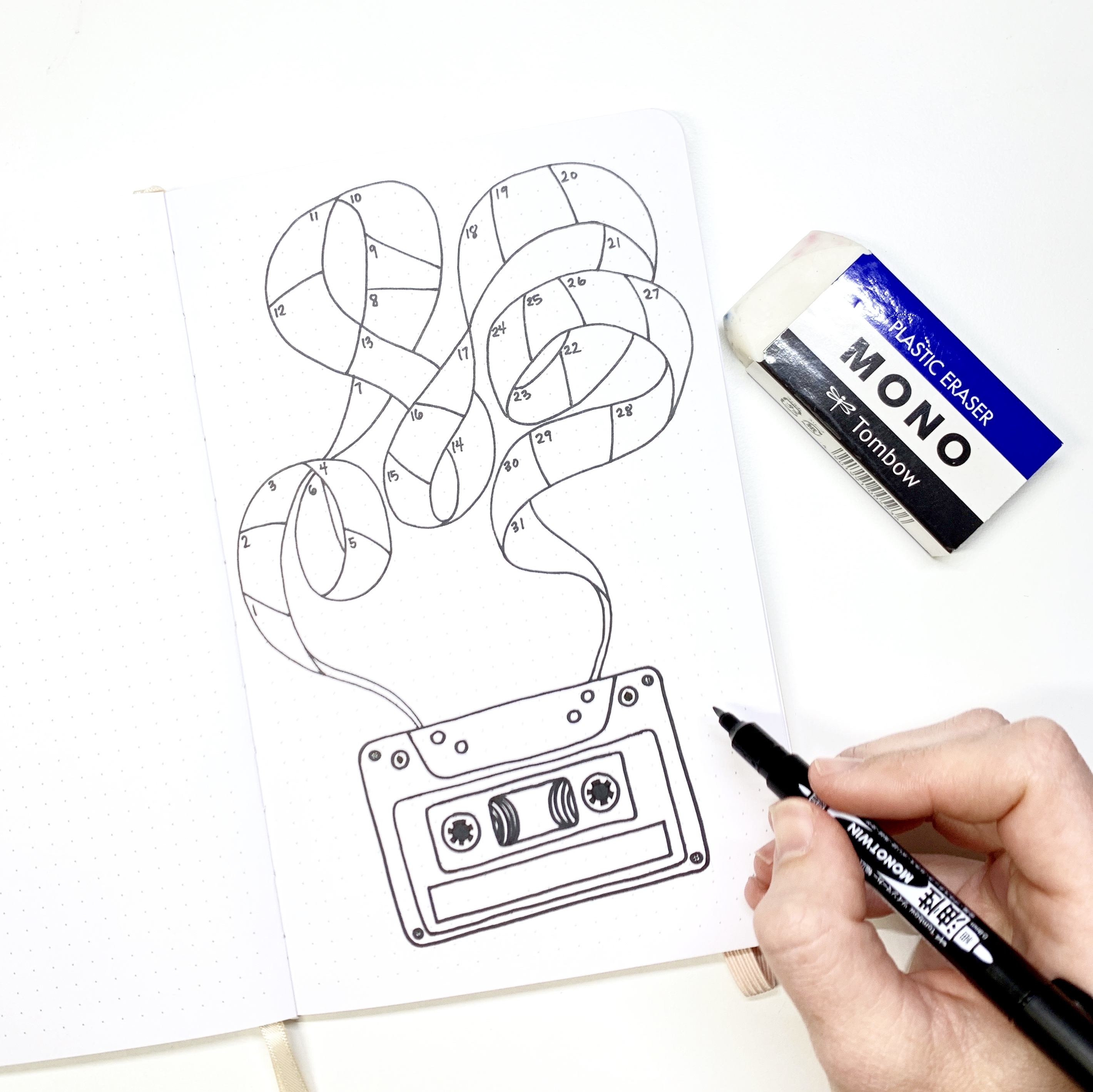 Learn how to create a cassette tape habit tracker in your dot grid notebook with Adrienne from @studio80design!