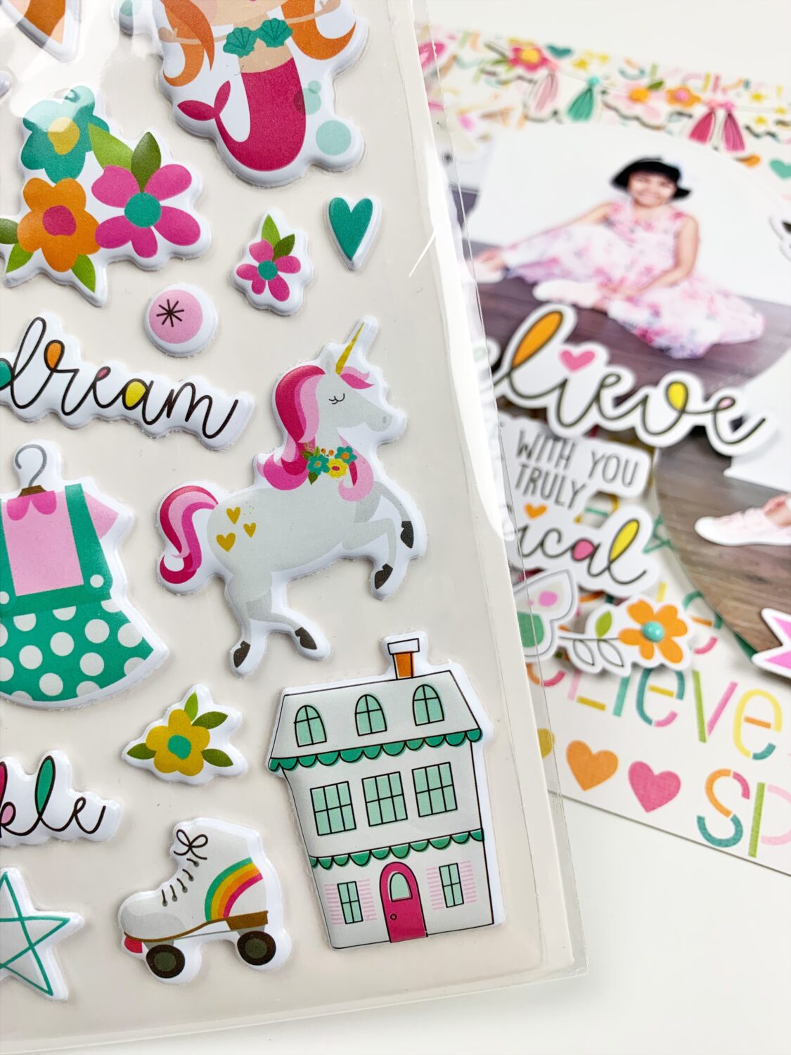 Use embellishments and stickers to decorate the image of the shadow box.  #tombow #shadowbox