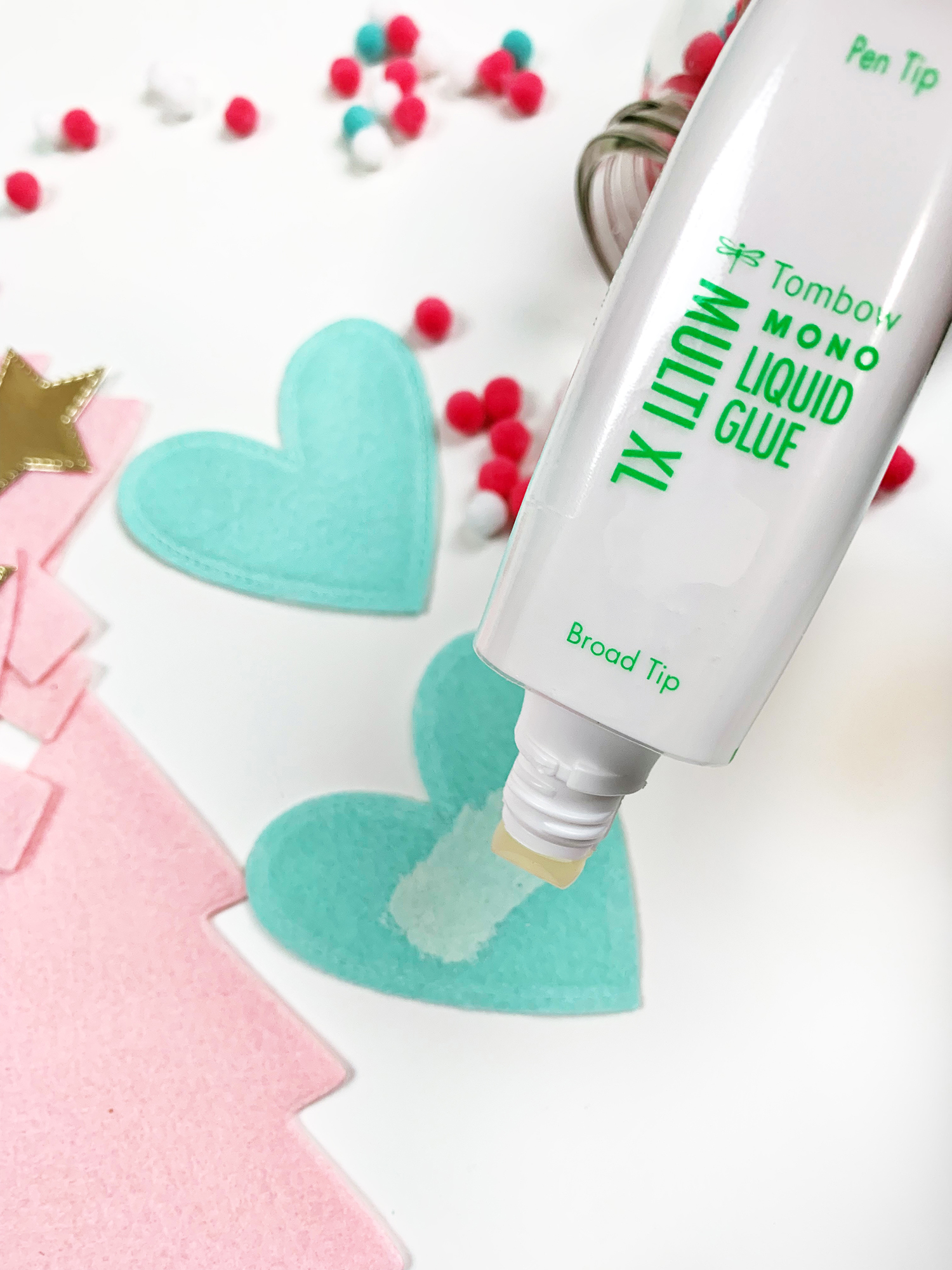 Use the Broad Tip of the Tombow MONO Multi XL Liquid Glue to apply a very light layer of glue to the heart. If you use too much glue it will bleed through the felt. A little bit works! #tombow #diy 