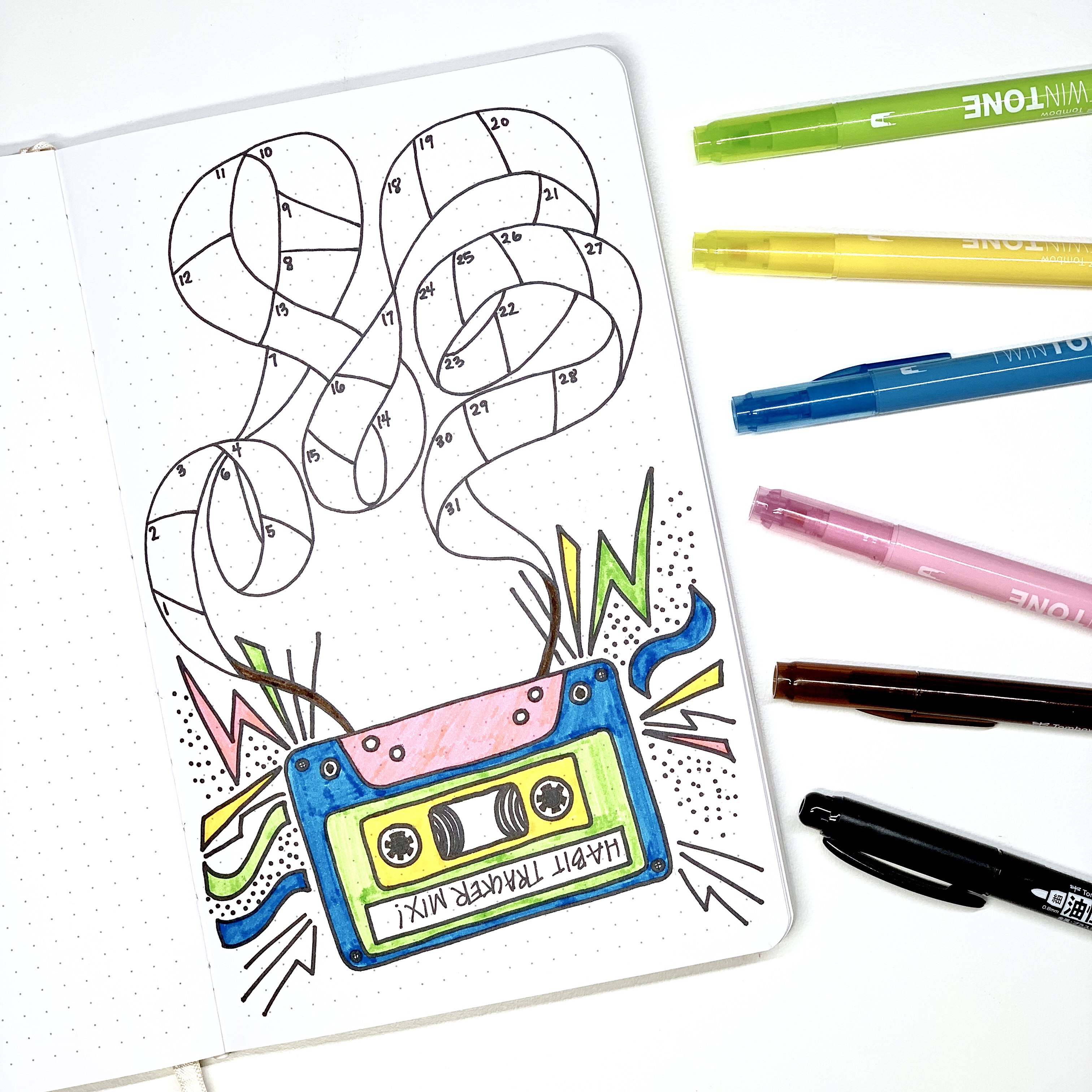 Learn how to create a cassette tape habit tracker in your dot grid notebook with Adrienne from @studio80design!