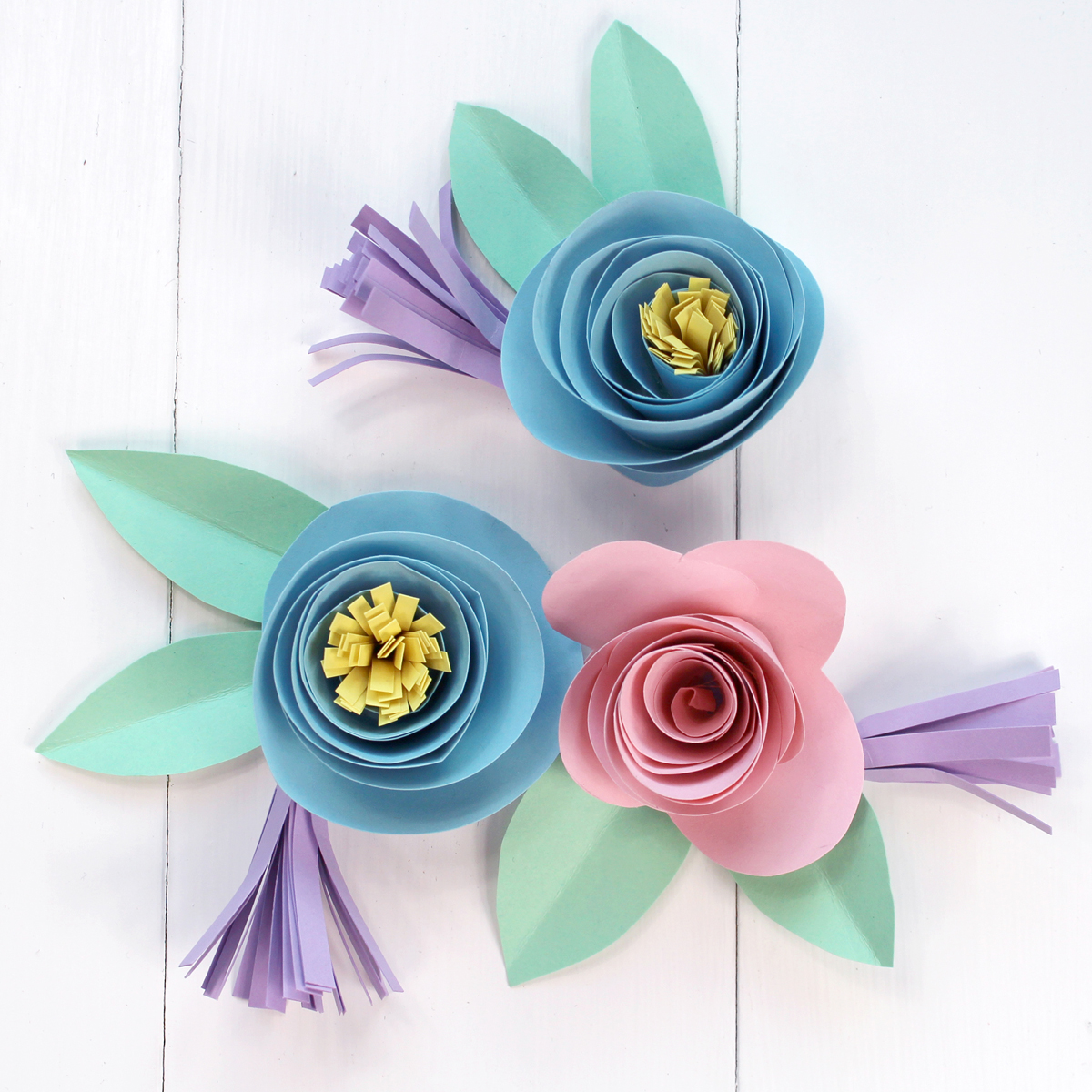 Pastel colored rolled paper flowers for Spring Banner DIY craft.