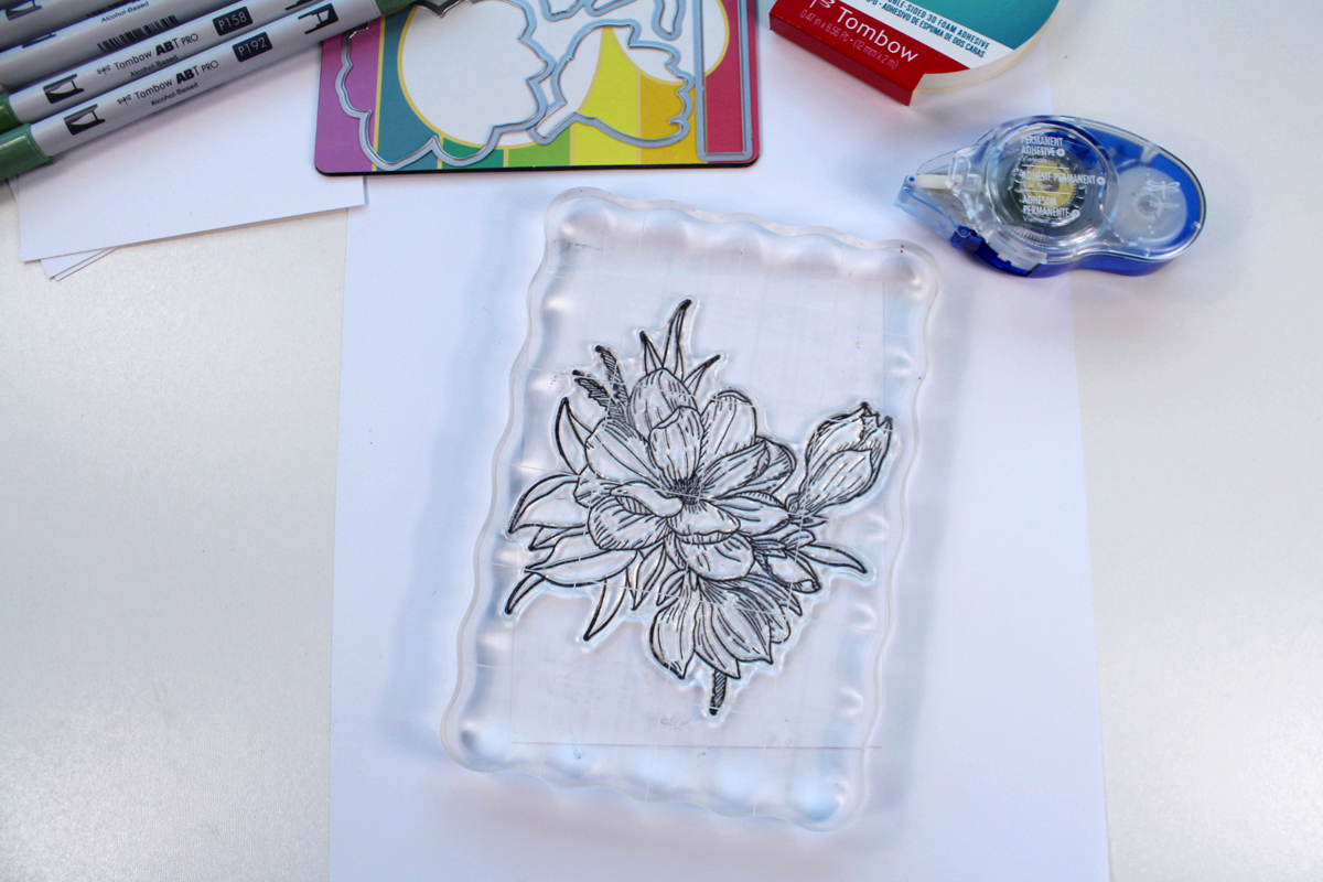 Stamping a handmade card with a flower stamp