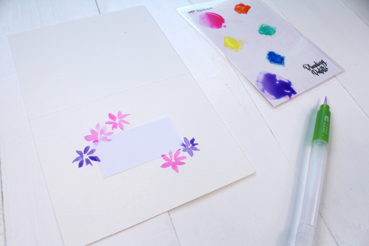 Paint watercolor flowers on the watercolor paper to make a greeting card.