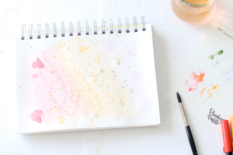 Use Tombow Dual Brush Pens as watercolors to create a watercolor splatter background for your hand lettering projects.