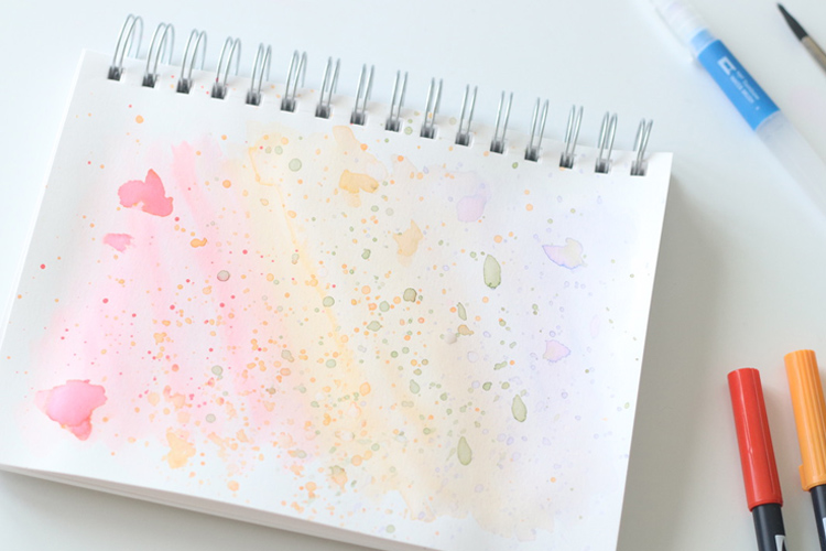 Use Tombow Dual Brush Pens as watercolors to create a watercolor splatter background for your hand lettering projects.