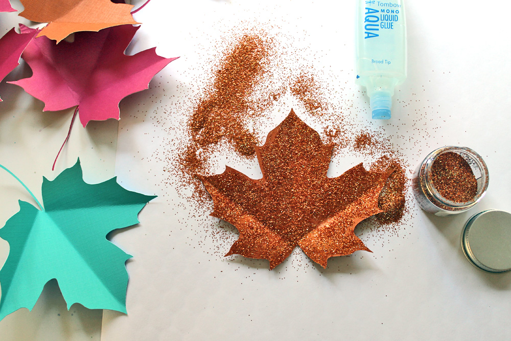 Create this easy Glitter Leaf Banner for your Fall Parties! DIY by @studiokatie for @tombowusa